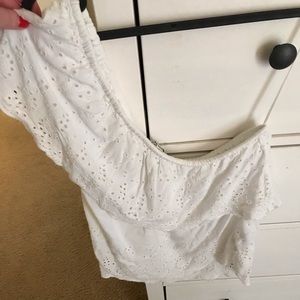 One shoulder white top.